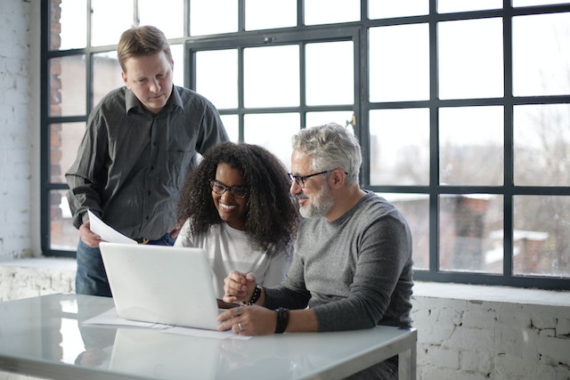 property-managers-sitting-at-desk-talking-and-looking-at-a-report